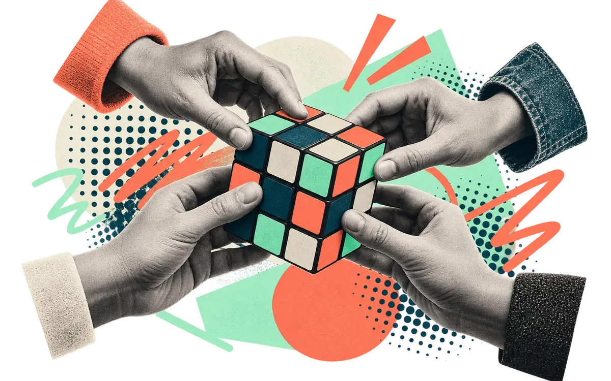 Four pairs of hands working together to solve a Rubik’s cube.